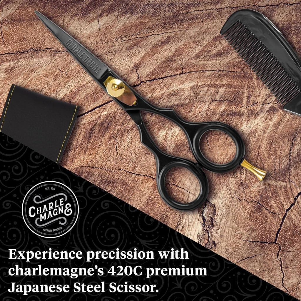 Black hair scissors with gold accents on a wooden surface