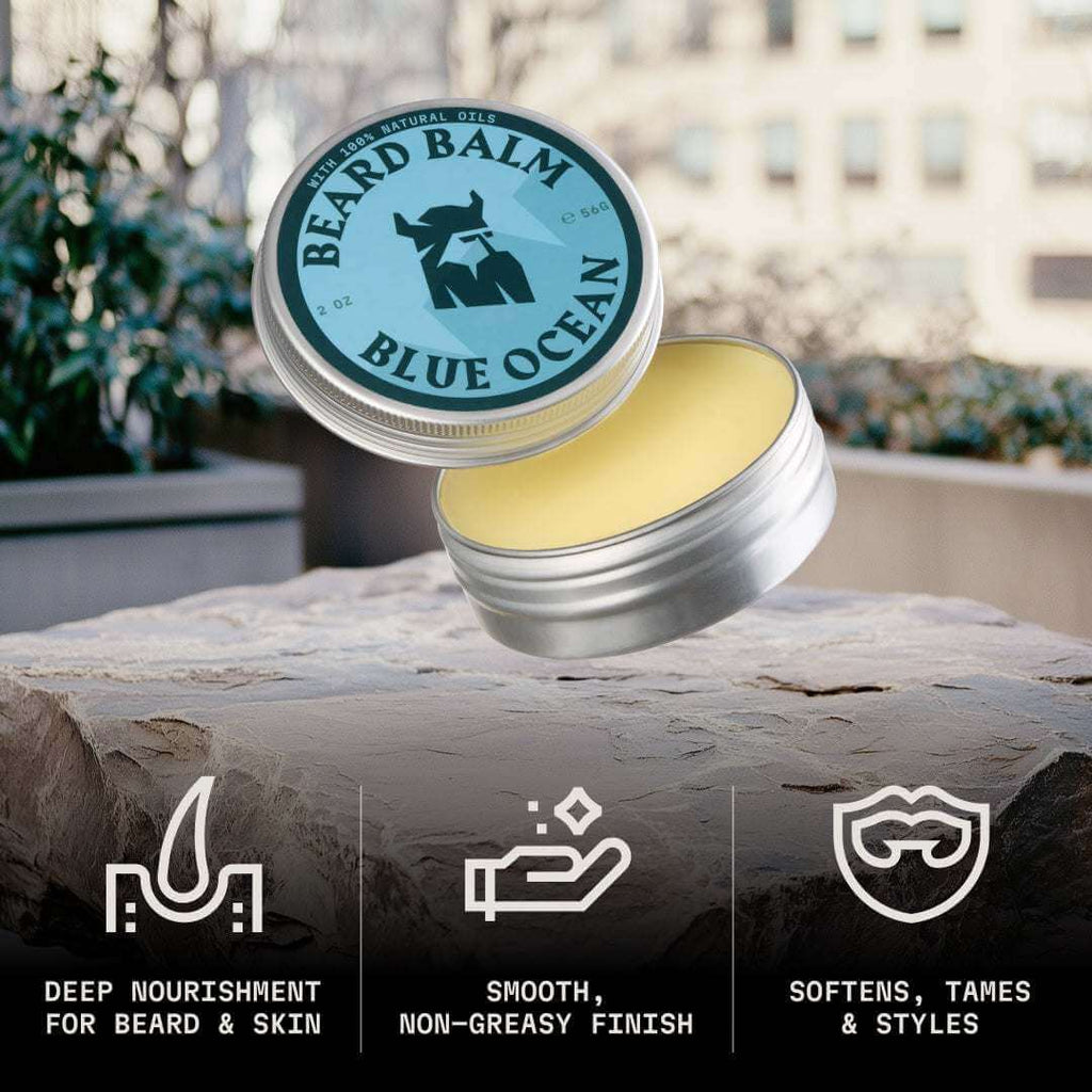 Beard balm container with lid open, showing product on a natural surface with outdoor background.